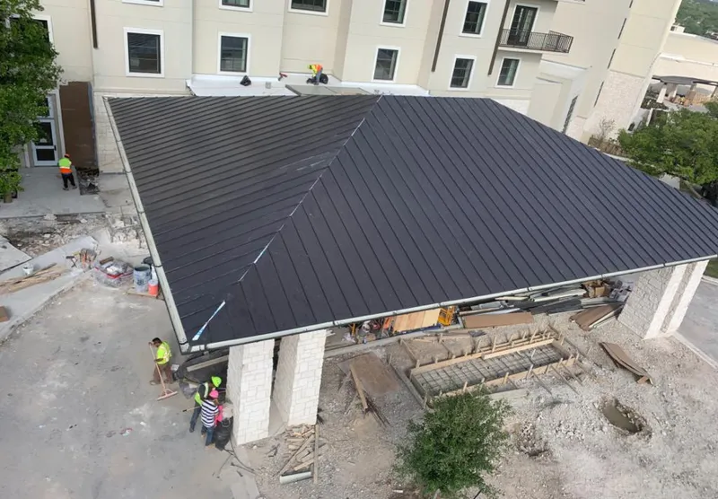 Metal roofing installation team working on a commercial building in University of Virginia